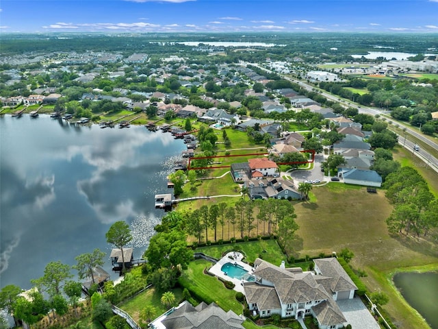 aerial view of residential area featuring a large body of water