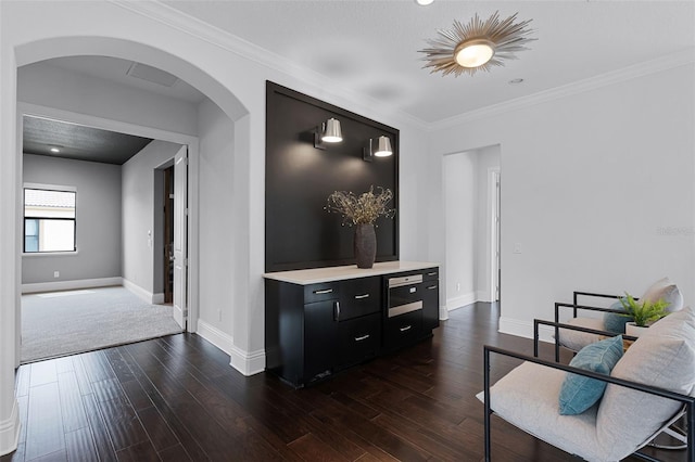 corridor featuring arched walkways, baseboards, dark wood-type flooring, and crown molding