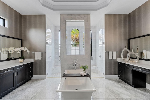 full bathroom featuring a shower stall, vanity, a freestanding tub, baseboards, and crown molding