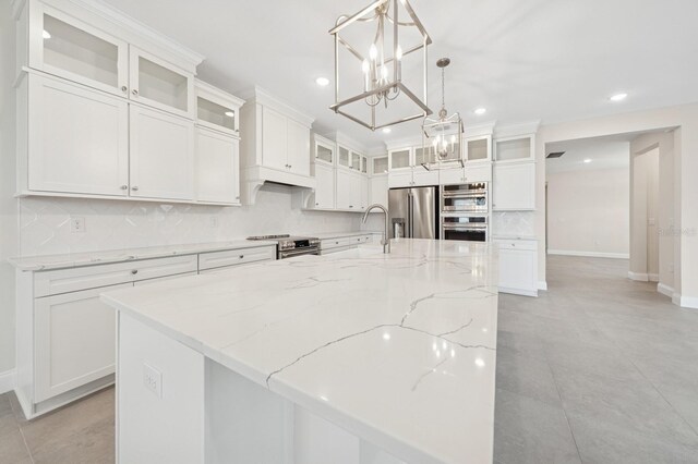 13187 Telsen St Unit 38, Winter Garden, FL 34787 - kitchen with appliances with stainless steel finishes, recessed lighting, tasteful backsplash, white cabinets, and a chandelier