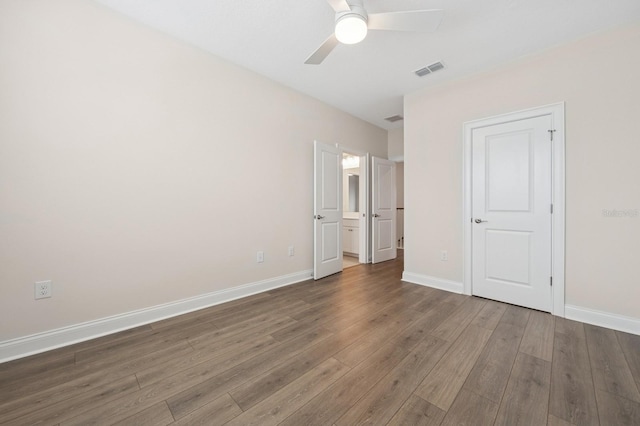 13187 Telsen St Unit 38, Winter Garden, FL 34787 - unfurnished bedroom featuring wood finished floors, ceiling fan, and connected bathroom