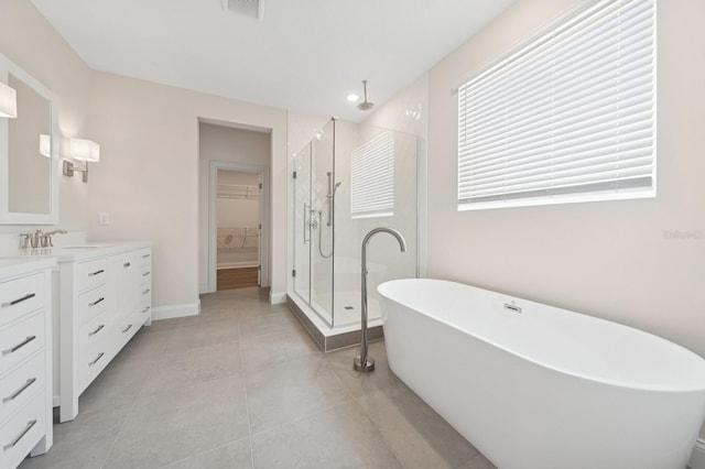 13187 Telsen St Unit 38, Winter Garden, FL 34787 - bathroom featuring a stall shower, vanity, a walk in closet, a freestanding tub, and tile patterned floors