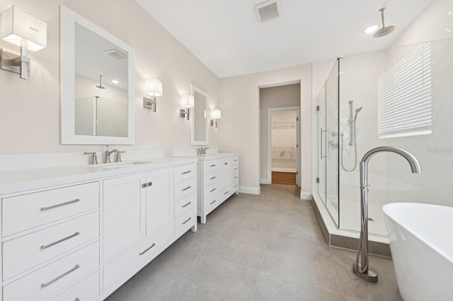 13187 Telsen St Unit 38, Winter Garden, FL 34787 - bathroom featuring a stall shower, double vanity, a freestanding bath, a spacious closet, and tile patterned flooring