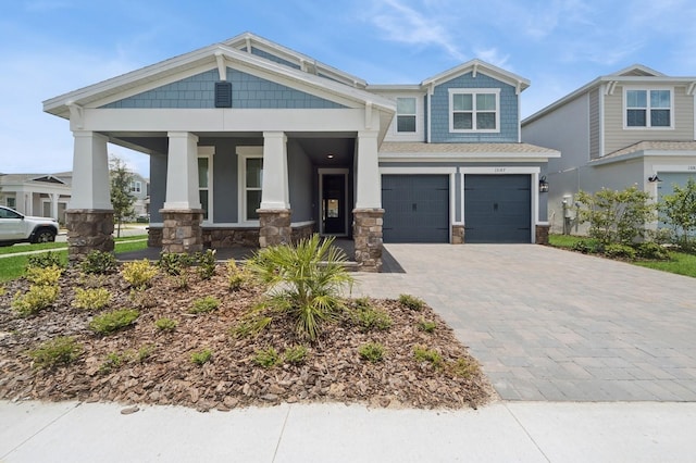 13187 Telsen St Unit 38, Winter Garden, FL 34787 - craftsman inspired home with a porch, decorative driveway, a garage, and stone siding