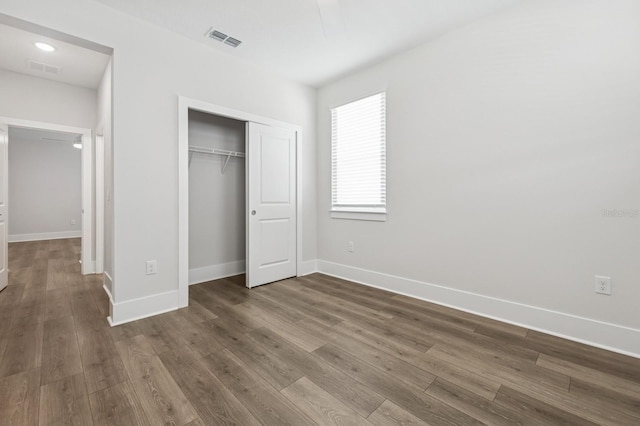 13181 Telsen St Unit 39, Winter Garden, FL 34787 - unfurnished bedroom featuring dark wood-type flooring and a closet