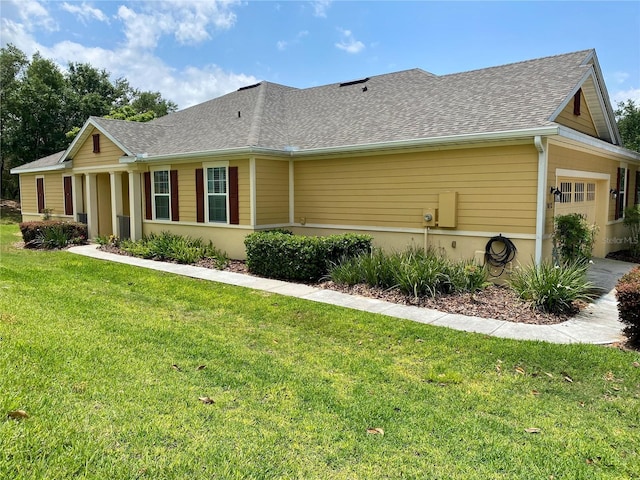 30732 Lipizzan Ter, Mount Dora, FL 32757 - view of side of home featuring a yard, a shingled roof, and an attached garage