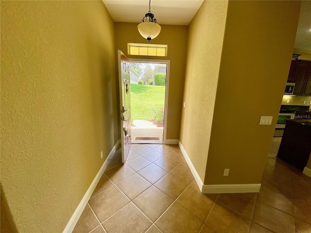 30732 Lipizzan Ter, Mount Dora, FL 32757 - entryway featuring baseboards, light tile patterned flooring, and a textured wall