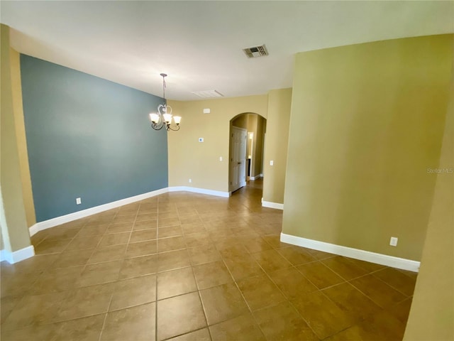 30732 Lipizzan Ter, Mount Dora, FL 32757 - spare room featuring visible vents, tile patterned flooring, arched walkways, and a notable chandelier