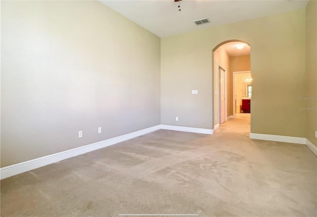 30732 Lipizzan Ter, Mount Dora, FL 32757 - spare room with baseboards, ceiling fan, visible vents, arched walkways, and light colored carpet