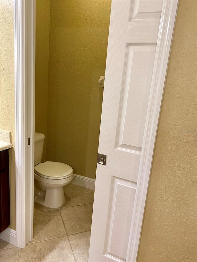 30732 Lipizzan Ter, Mount Dora, FL 32757 - bathroom featuring toilet, tile patterned flooring, baseboards, and a textured wall