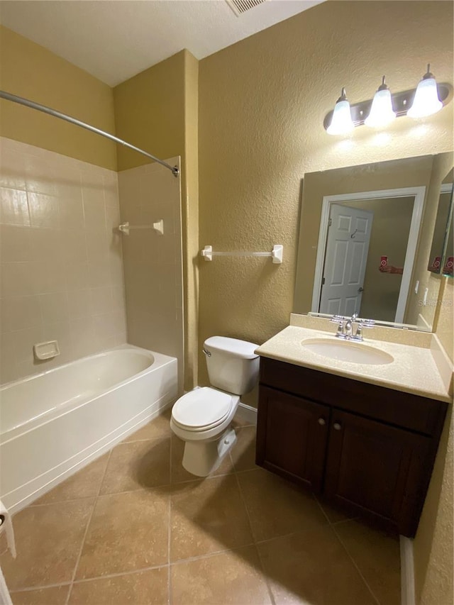 30732 Lipizzan Ter, Mount Dora, FL 32757 - bathroom with toilet, tile patterned floors, vanity, bathing tub / shower combination, and a textured wall