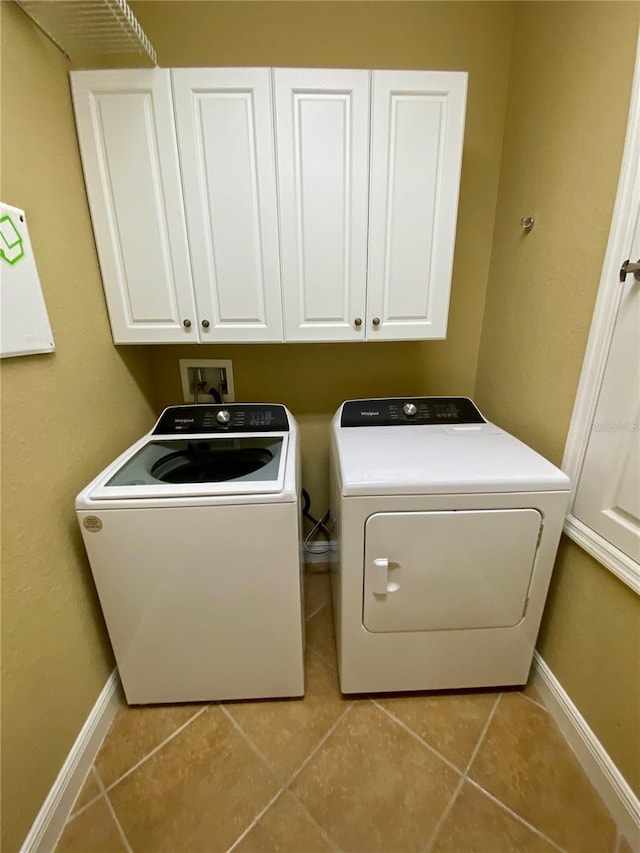 30732 Lipizzan Ter, Mount Dora, FL 32757 - laundry area featuring light tile patterned flooring, cabinet space, baseboards, and washer and dryer