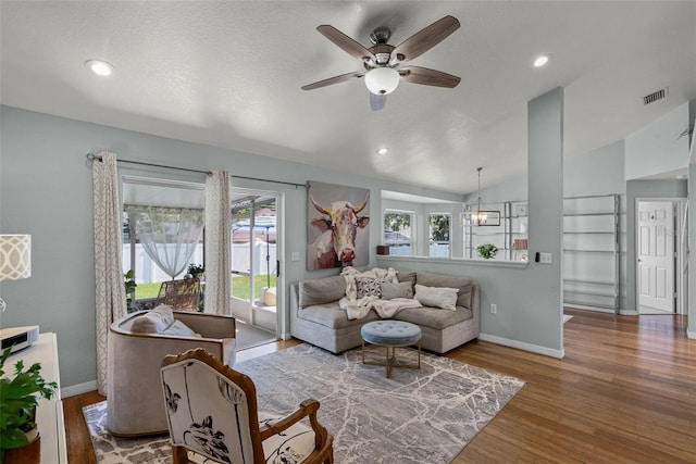 living room with a ceiling fan, wood finished floors, baseboards, lofted ceiling, and recessed lighting