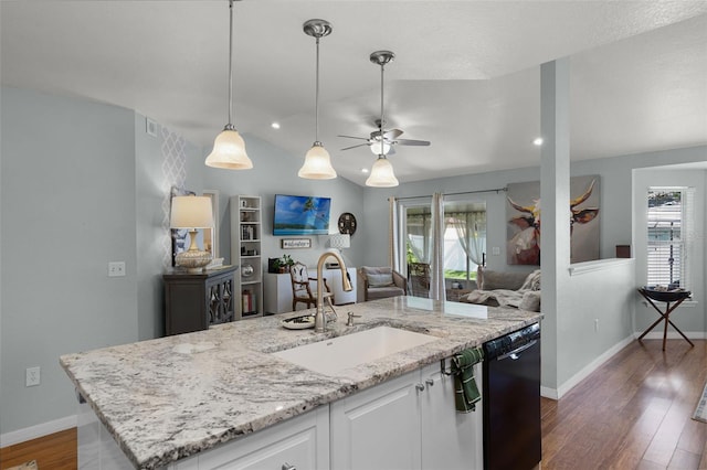 kitchen with a sink, open floor plan, ceiling fan, dark wood-type flooring, and dishwasher