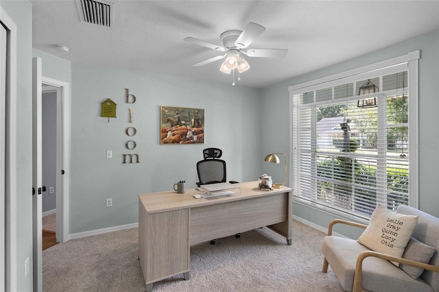 home office with light colored carpet, baseboards, and a ceiling fan