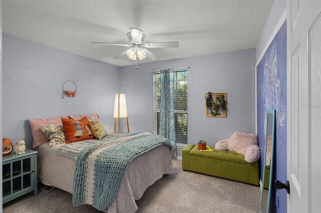 bedroom with carpet flooring, a ceiling fan, and a textured ceiling