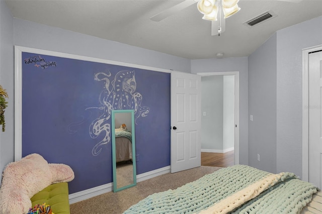 carpeted bedroom with baseboards and ceiling fan