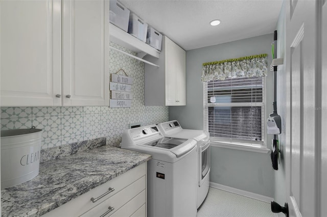 washroom with cabinet space, independent washer and dryer, and baseboards