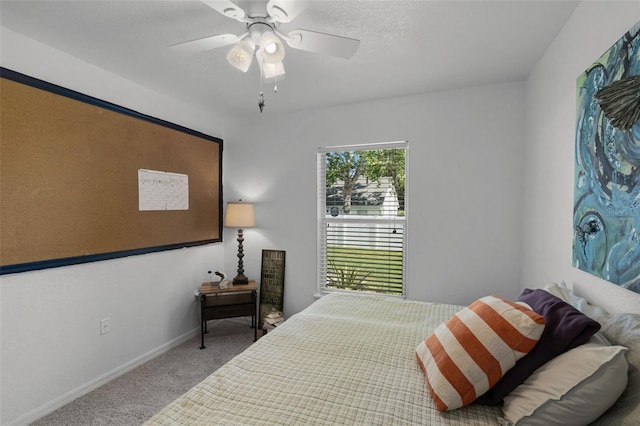 carpeted bedroom with baseboards and a ceiling fan