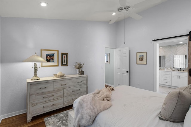 bedroom featuring recessed lighting, baseboards, connected bathroom, high vaulted ceiling, and wood finished floors