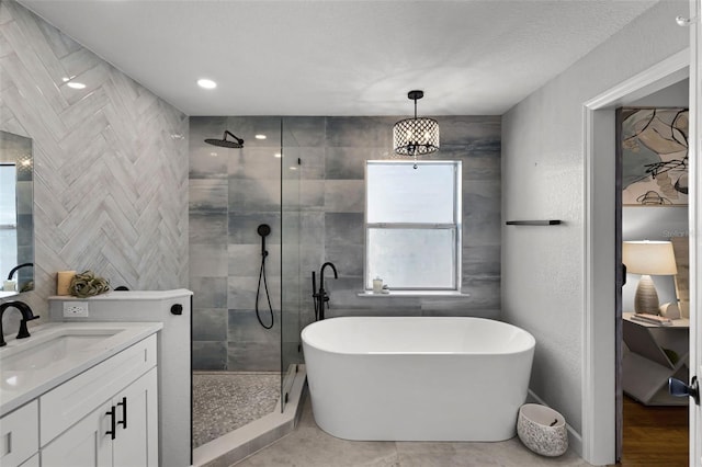 full bath with a tile shower, plenty of natural light, and vanity