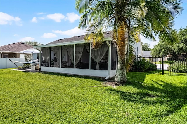 back of house featuring a sunroom