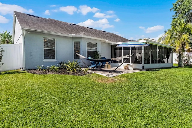 back of house with a sunroom, stucco siding, a patio area, and roof with shingles