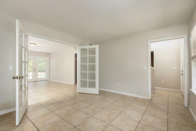 2320 Red Ember Rd, Oviedo, FL 32765 - empty room featuring french doors, light tile patterned flooring, and baseboards