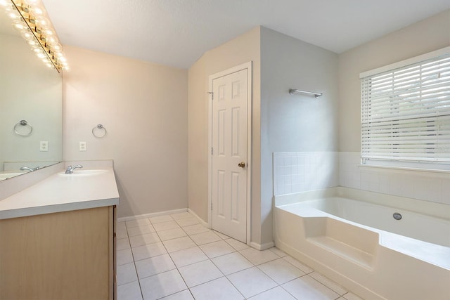 2320 Red Ember Rd, Oviedo, FL 32765 - full bathroom featuring tile patterned floors, vanity, a garden tub, and baseboards