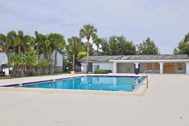 pool featuring fence and a patio