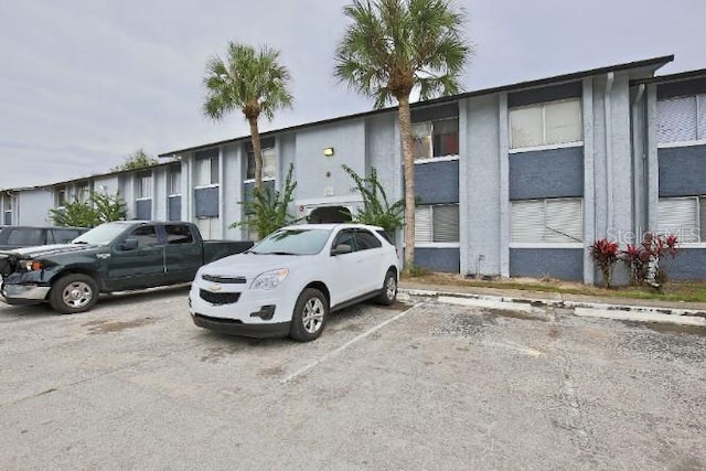 view of property with uncovered parking