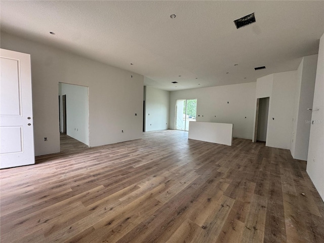 unfurnished living room featuring wood finished floors