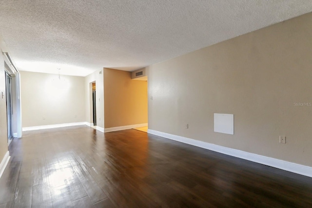 4727 S Texas Ave Unit 4727C, Orlando, FL 32839 - unfurnished room featuring a textured ceiling, baseboards, visible vents, and dark wood finished floors