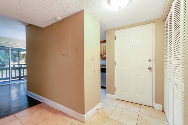 4727 S Texas Ave Unit 4727C, Orlando, FL 32839 - hall with a textured ceiling, baseboards, and light tile patterned floors