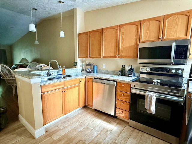 963 Stucki Ter, Winter Garden, FL 34787 - kitchen with a sink, light wood finished floors, stainless steel appliances, and lofted ceiling