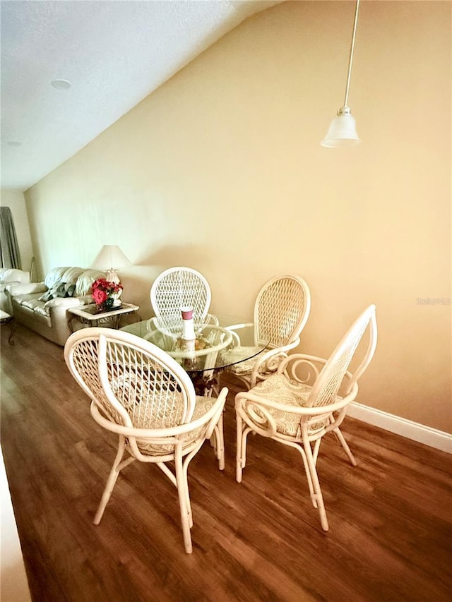 963 Stucki Ter, Winter Garden, FL 34787 - dining space with baseboards, vaulted ceiling, and wood finished floors