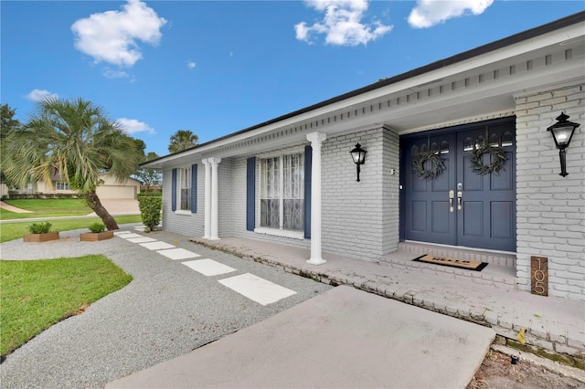 entrance to property featuring brick siding