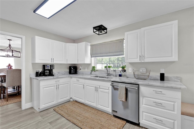 kitchen with white cabinets, dishwasher, light wood-type flooring, and a sink