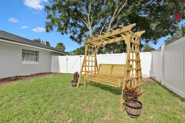 view of yard with a gate, a pergola, and a fenced backyard