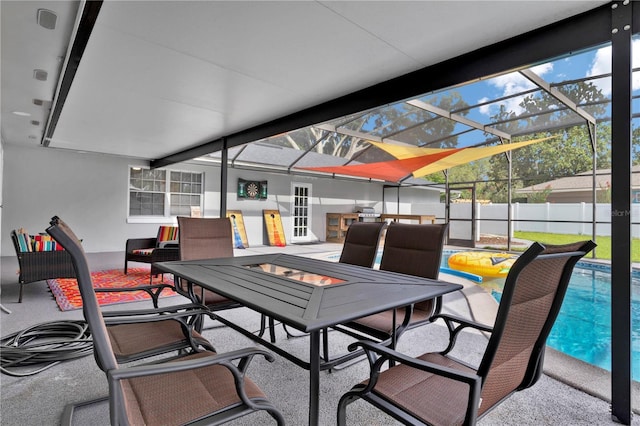 view of patio with an outdoor fire pit, a fenced in pool, fence, and a lanai