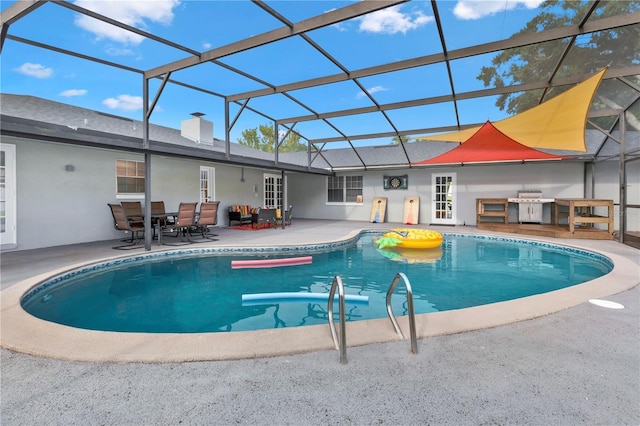 outdoor pool featuring outdoor dining space, area for grilling, exterior kitchen, a patio, and a lanai