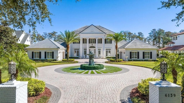 greek revival inspired property with curved driveway
