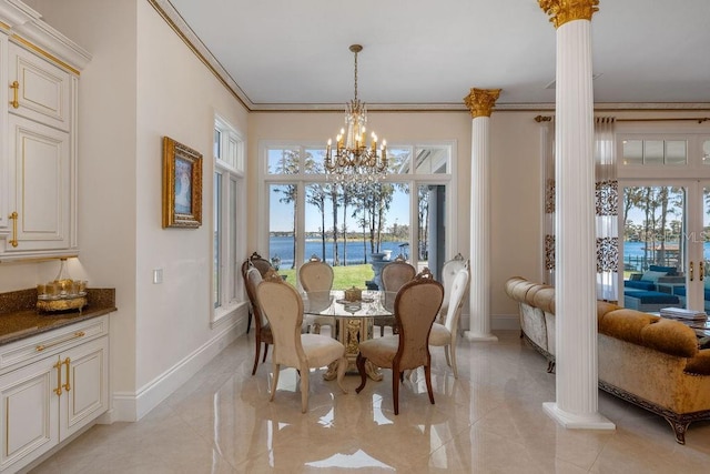 dining space with ornate columns, baseboards, a chandelier, healthy amount of natural light, and ornamental molding