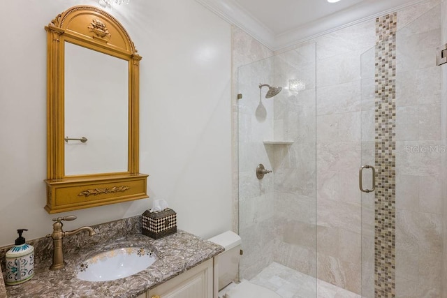 bathroom featuring a shower stall, toilet, vanity, and crown molding