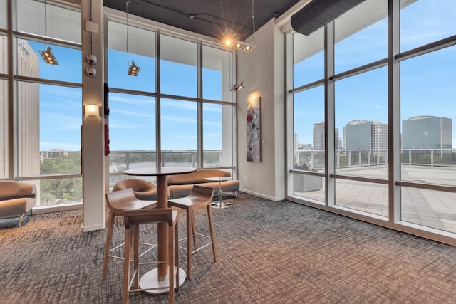 150 E Robinson St Unit 2002, Orlando, FL 32801 - carpeted dining area featuring a high ceiling, baseboards, and expansive windows