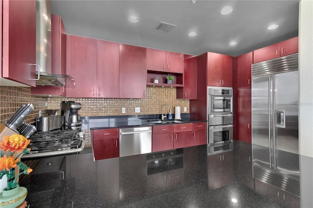 150 E Robinson St Unit 2002, Orlando, FL 32801 - kitchen featuring appliances with stainless steel finishes, wall chimney exhaust hood, a sink, red cabinets, and recessed lighting