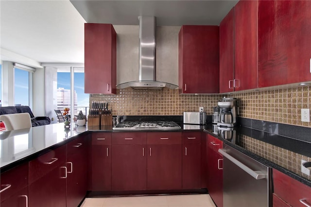 150 E Robinson St Unit 2002, Orlando, FL 32801 - kitchen featuring wall chimney range hood, red cabinets, appliances with stainless steel finishes, decorative backsplash, and dark countertops