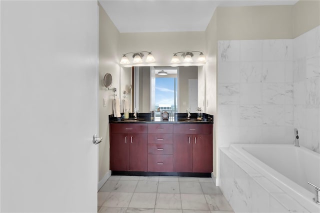 150 E Robinson St Unit 2002, Orlando, FL 32801 - bathroom featuring a garden tub, marble finish floors, double vanity, and baseboards