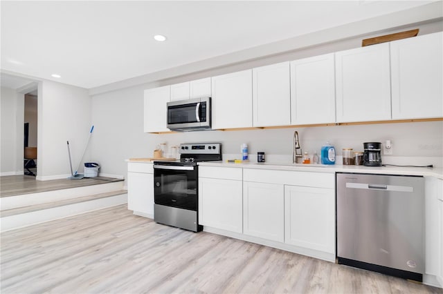 2927 Ahern Dr, Orlando, FL 32817 - kitchen with recessed lighting, light countertops, appliances with stainless steel finishes, and a sink
