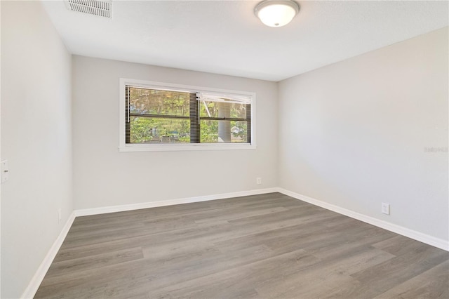 2927 Ahern Dr, Orlando, FL 32817 - empty room with visible vents, wood finished floors, and baseboards